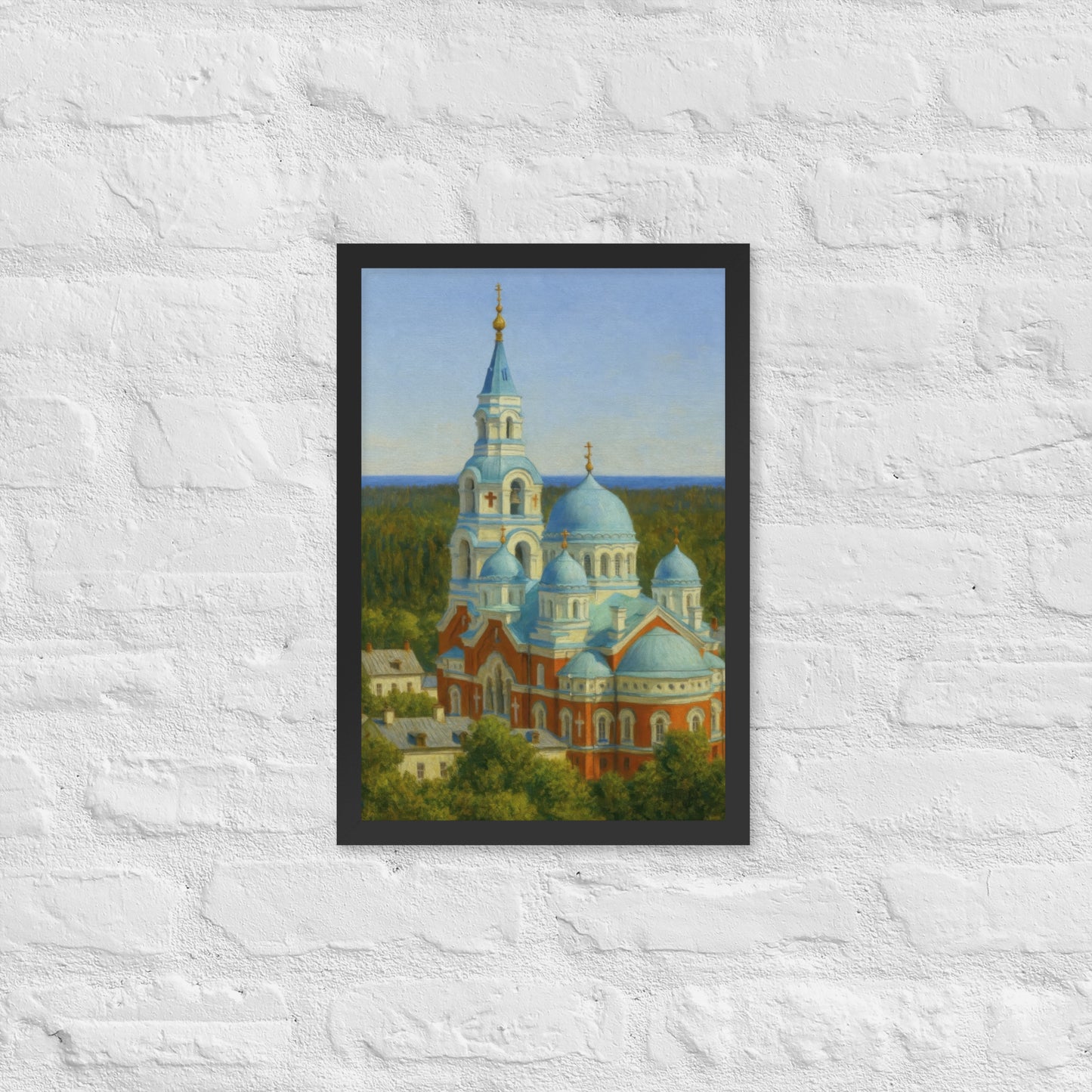 Framed artwork of a cathedral with blue domes on a white brick wall