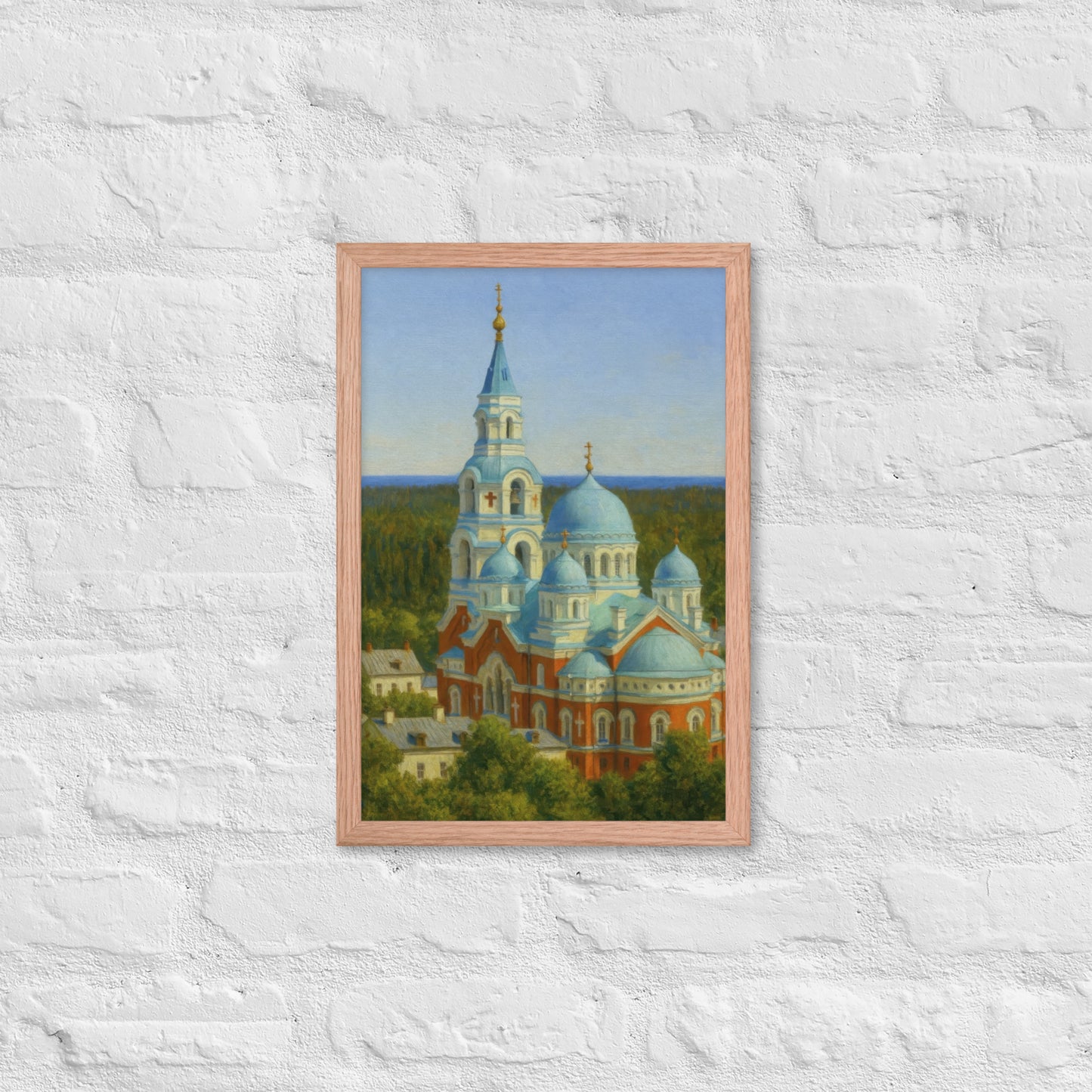 Framed painting of a church with blue domes on a white brick wall