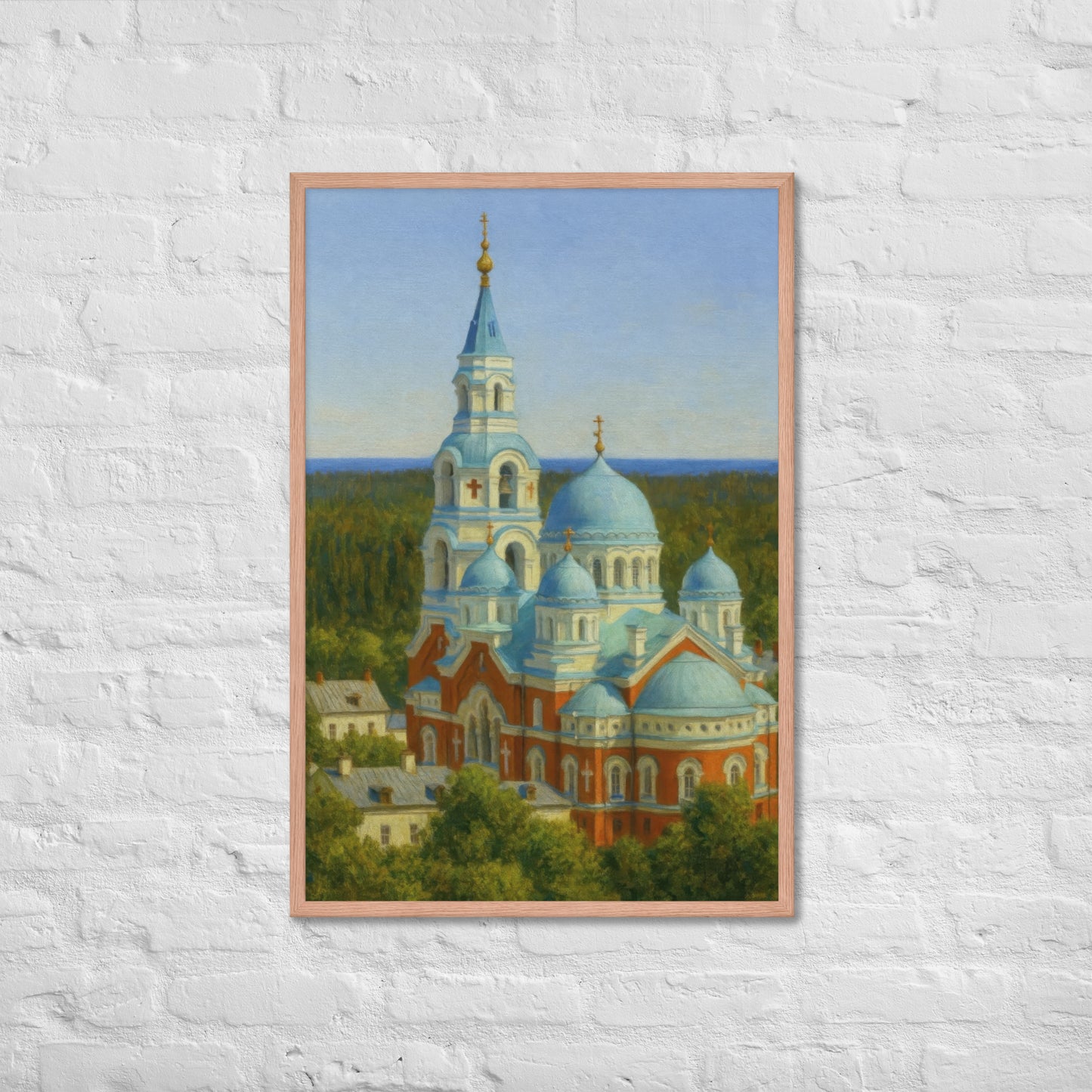 Framed painting of a church with blue domes on a white brick wall